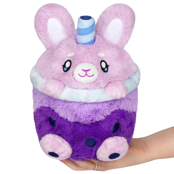 A plush toy shaped like a purple boba tea cup with a bunny face, ears, and a striped straw on top